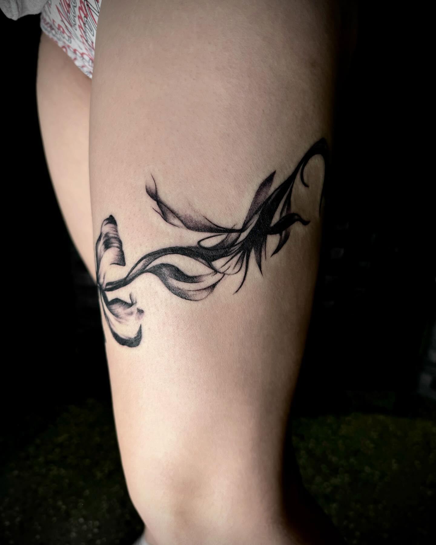 Abstract dragon tribal tattoo on the thigh by oh hey, robin.