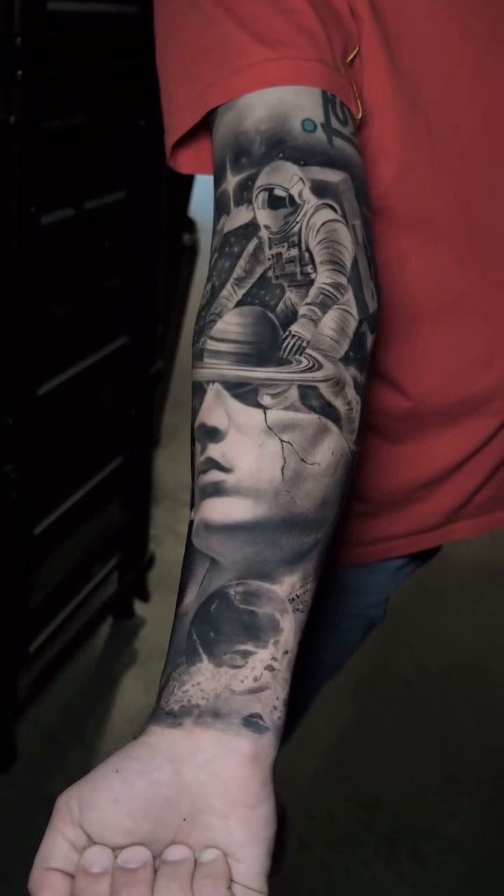 Astronaut and ancient figure realism tattoo by Martin Reyes Jr