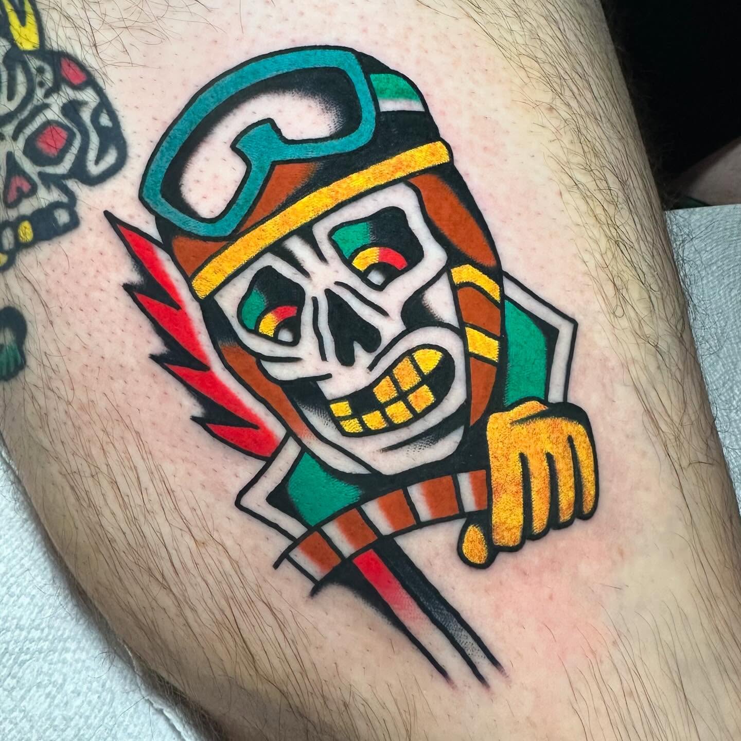 Skull wearing helmet American traditional tattoo on the thigh by Mr. Brent