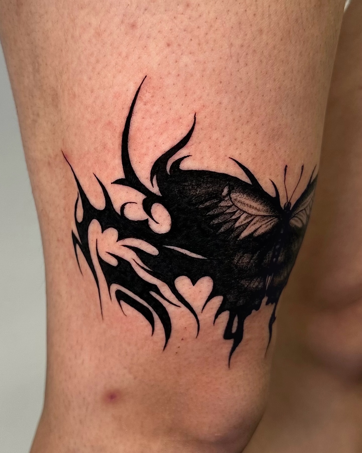 Abstract flame tribal tattoo on the thigh by Mystikal Blue Casares