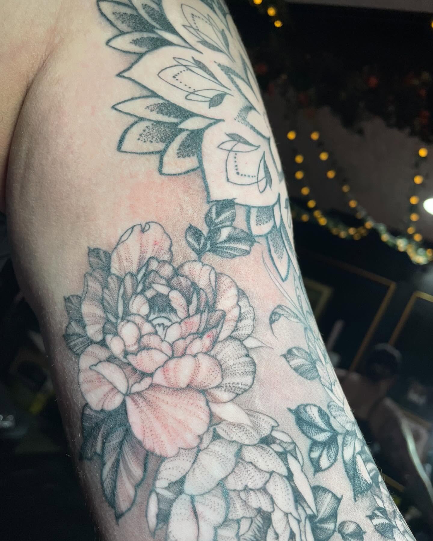 Peony and floral dotwork tattoo on the forearm by Tayler Beetison