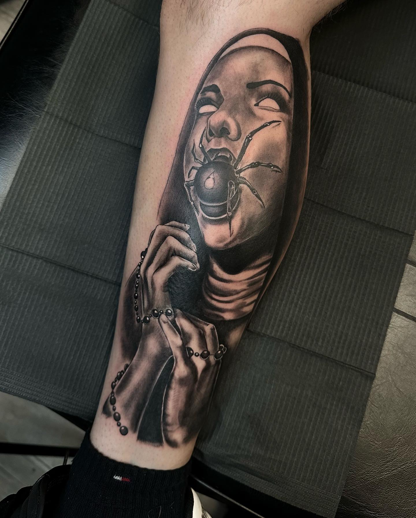 Nun with spider realism tattoo on the forearm by Hugo Ruiz-Esparza