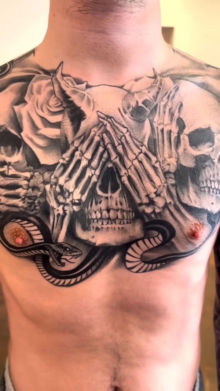 Skulls, roses, and praying hands dark realism tattoo by Mason Williams