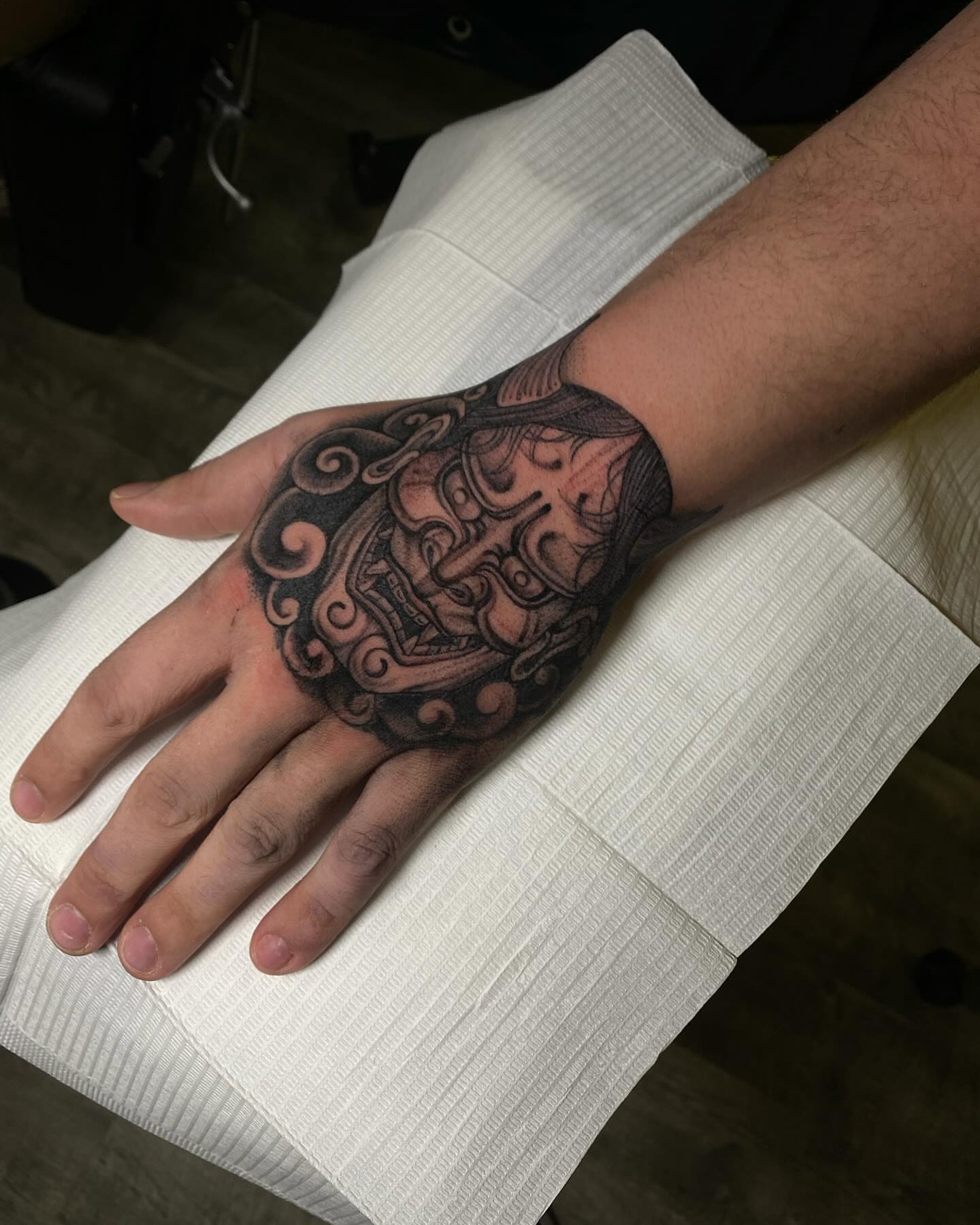 Mask black and grey tattoo on the hand by Chase Skylar Clayton Ogle