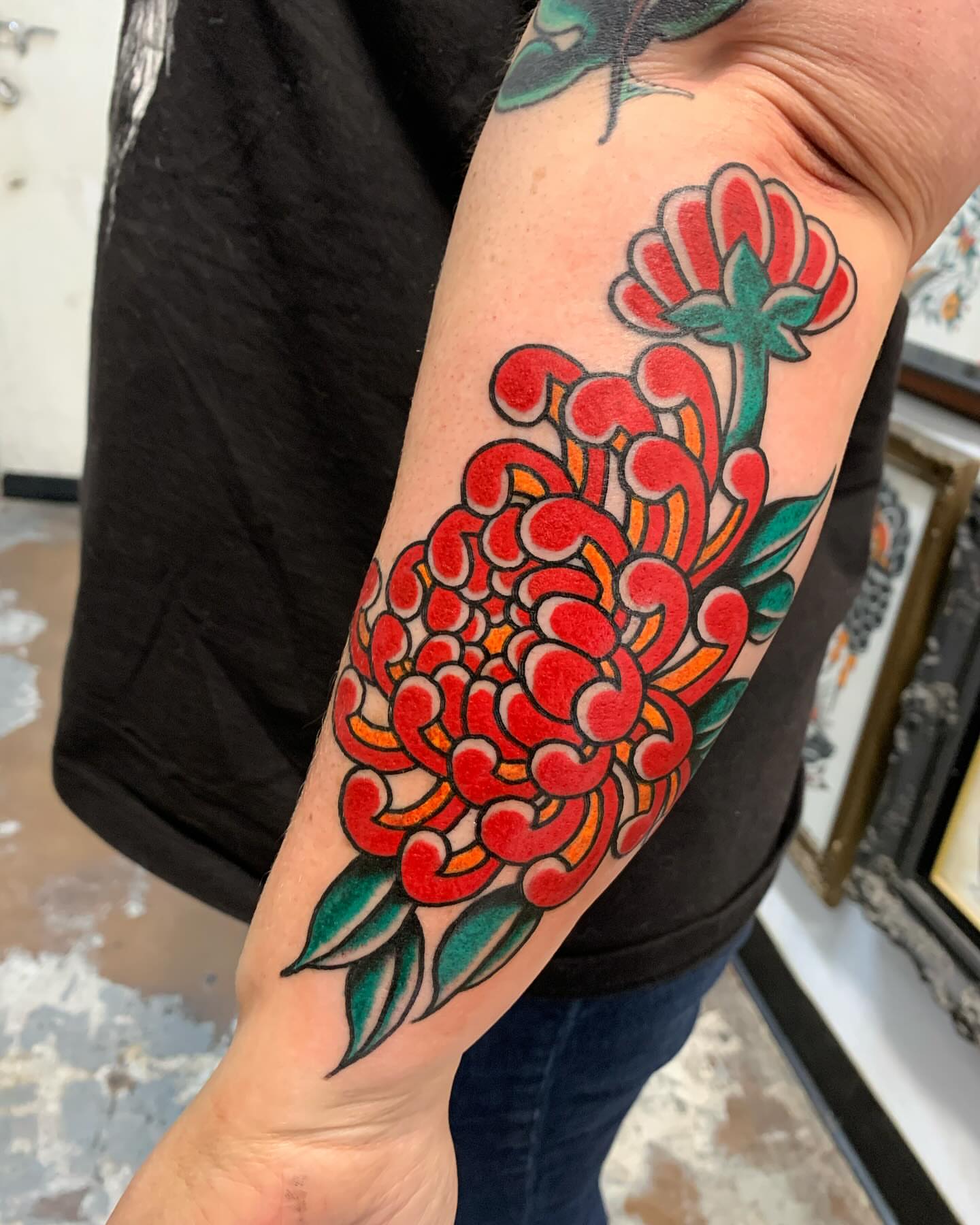 Chrysanthemum American traditional tattoo on the forearm by Chrissie