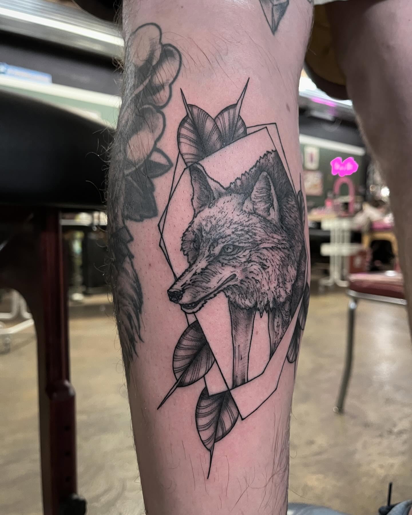 Wolf geometric tattoo on the forearm by Dallas Davis