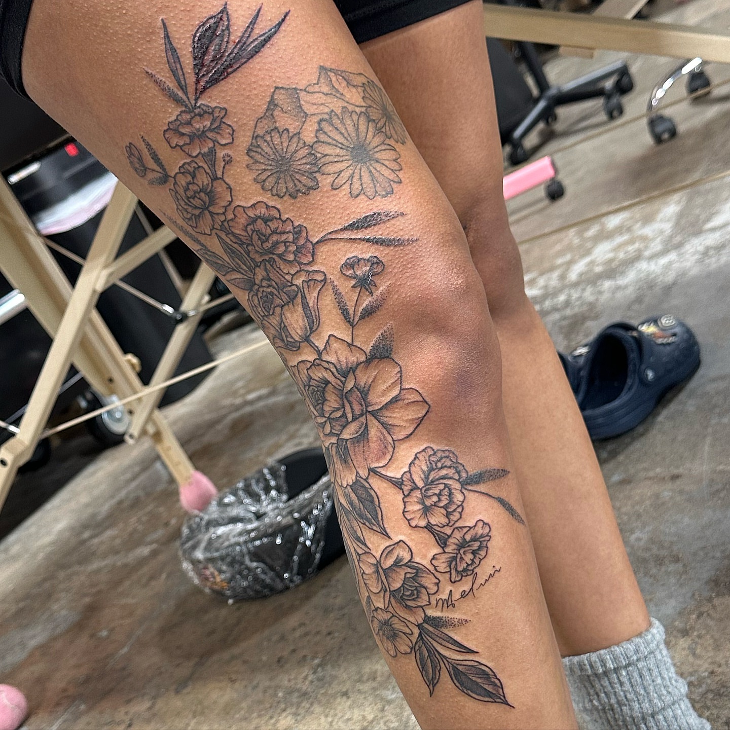 Floral arrangement black and grey tattoo on the leg by Emily K Lingg