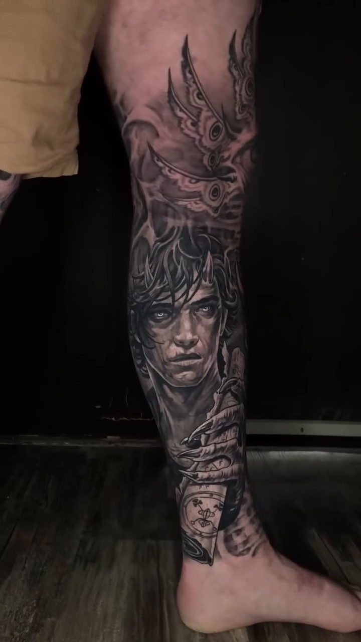 Demonic figures and mechanical elements dark realism tattoo by Oak Adams