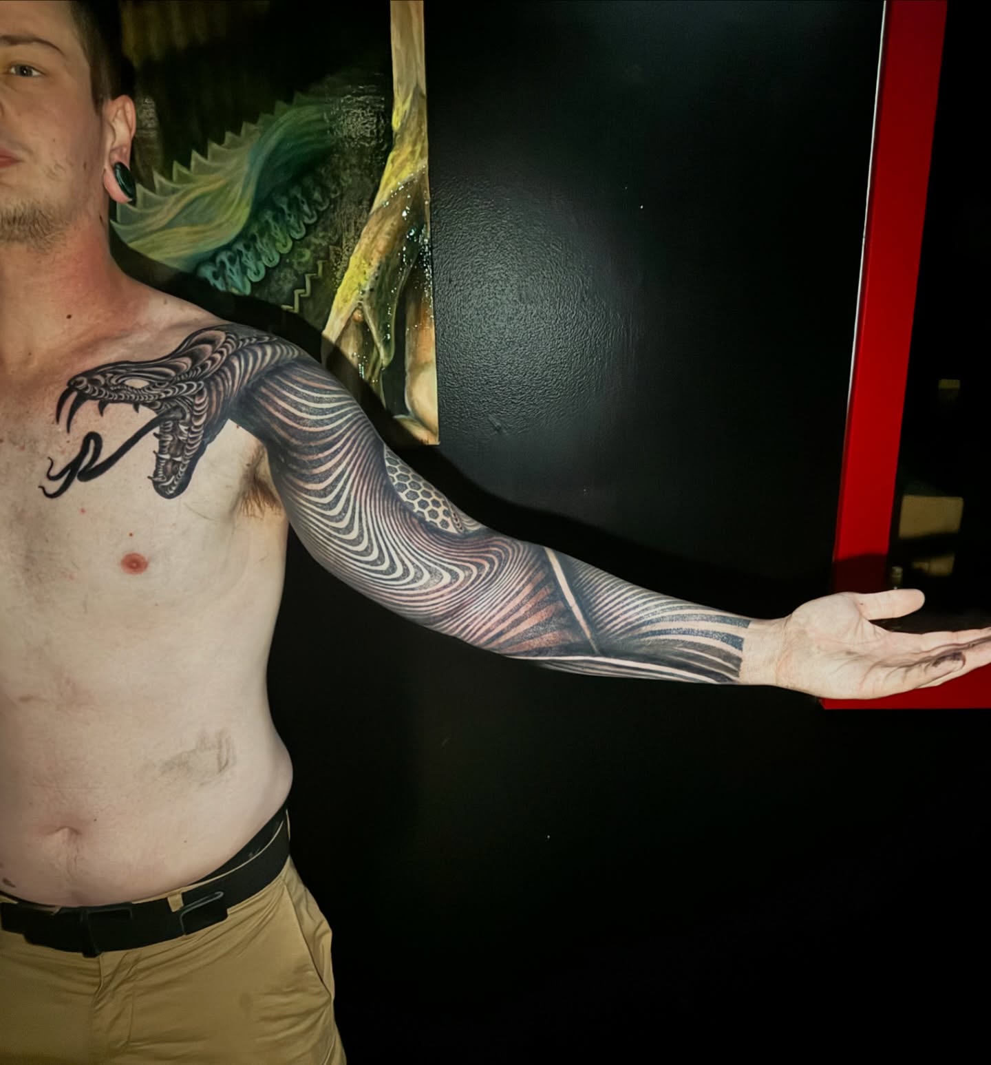 Snake realism tattoo on the upper arm by Jordan Rookus
