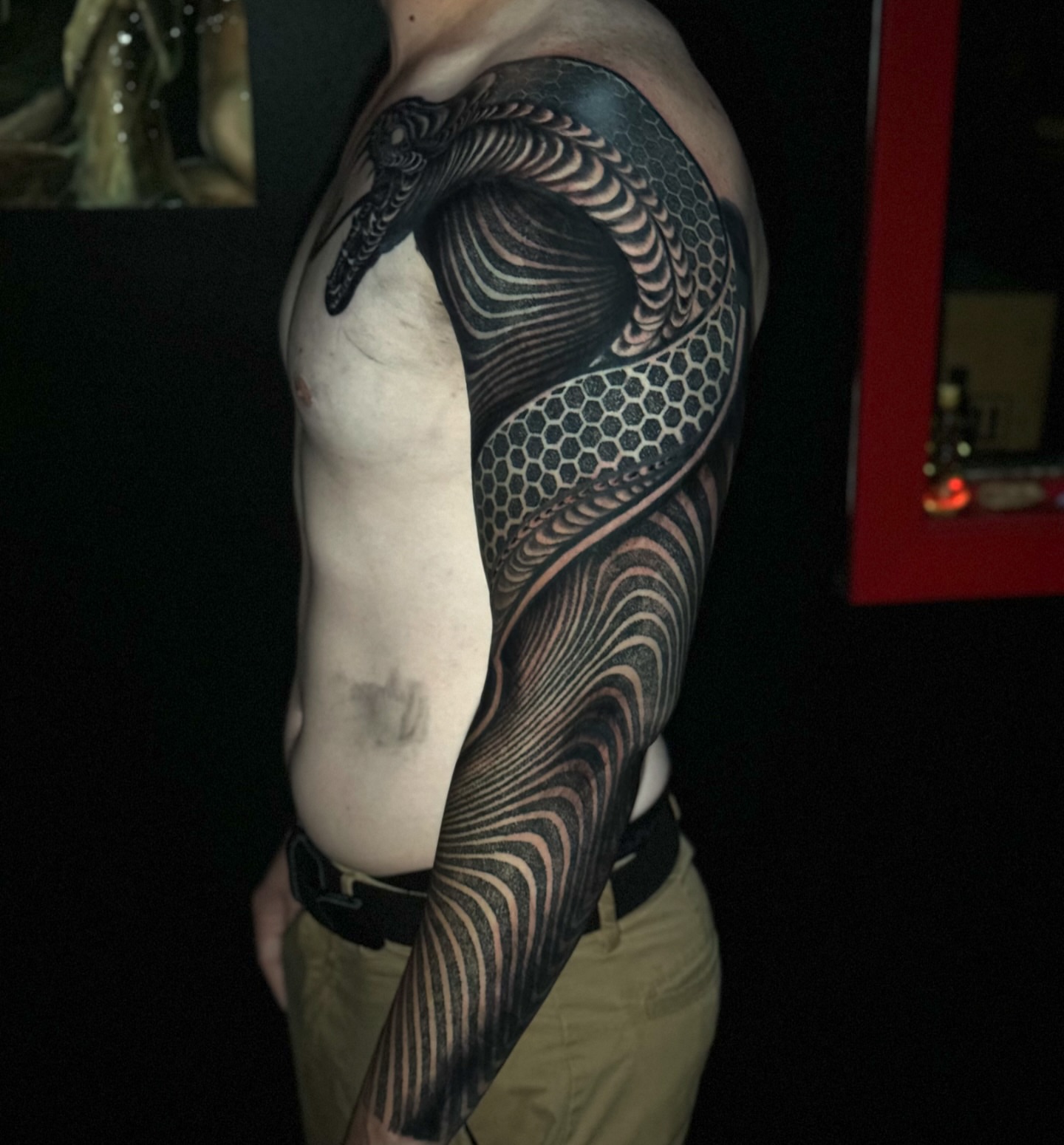 Snake geometric tattoo on the upper arm by Jordan Rookus