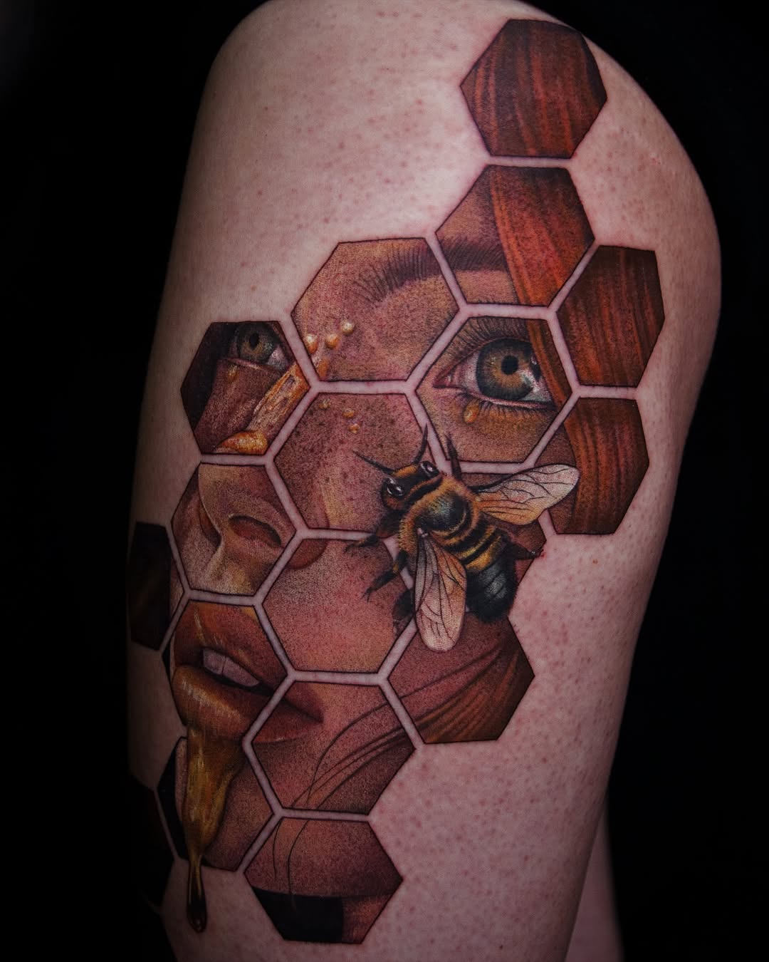 Bee and face in honeycomb surrealism tattoo on the shoulder by caliope yiannos