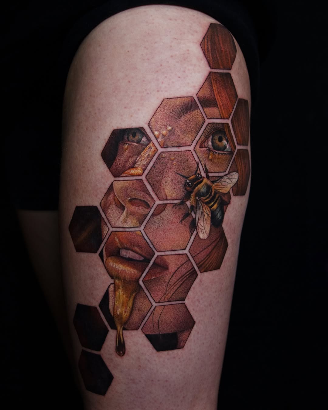 Face and bee in honeycomb surrealism tattoo on the forearm by caliope yiannos