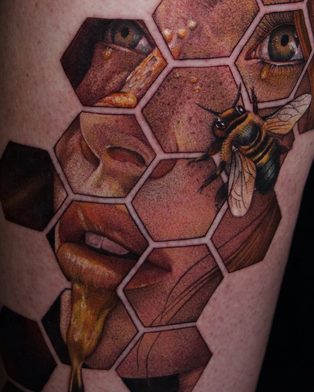 Bee and human face in honeycomb surrealism tattoo on the forearm by caliope yiannos
