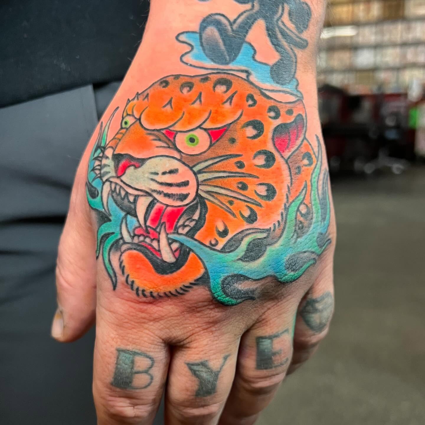 Jaguar American traditional tattoo on the hand by Dustin Hysell