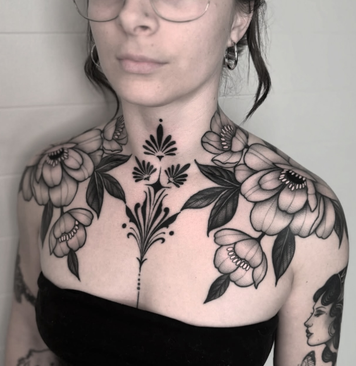 Floral arrangement geometric tattoo on the chest by Luna Lucero