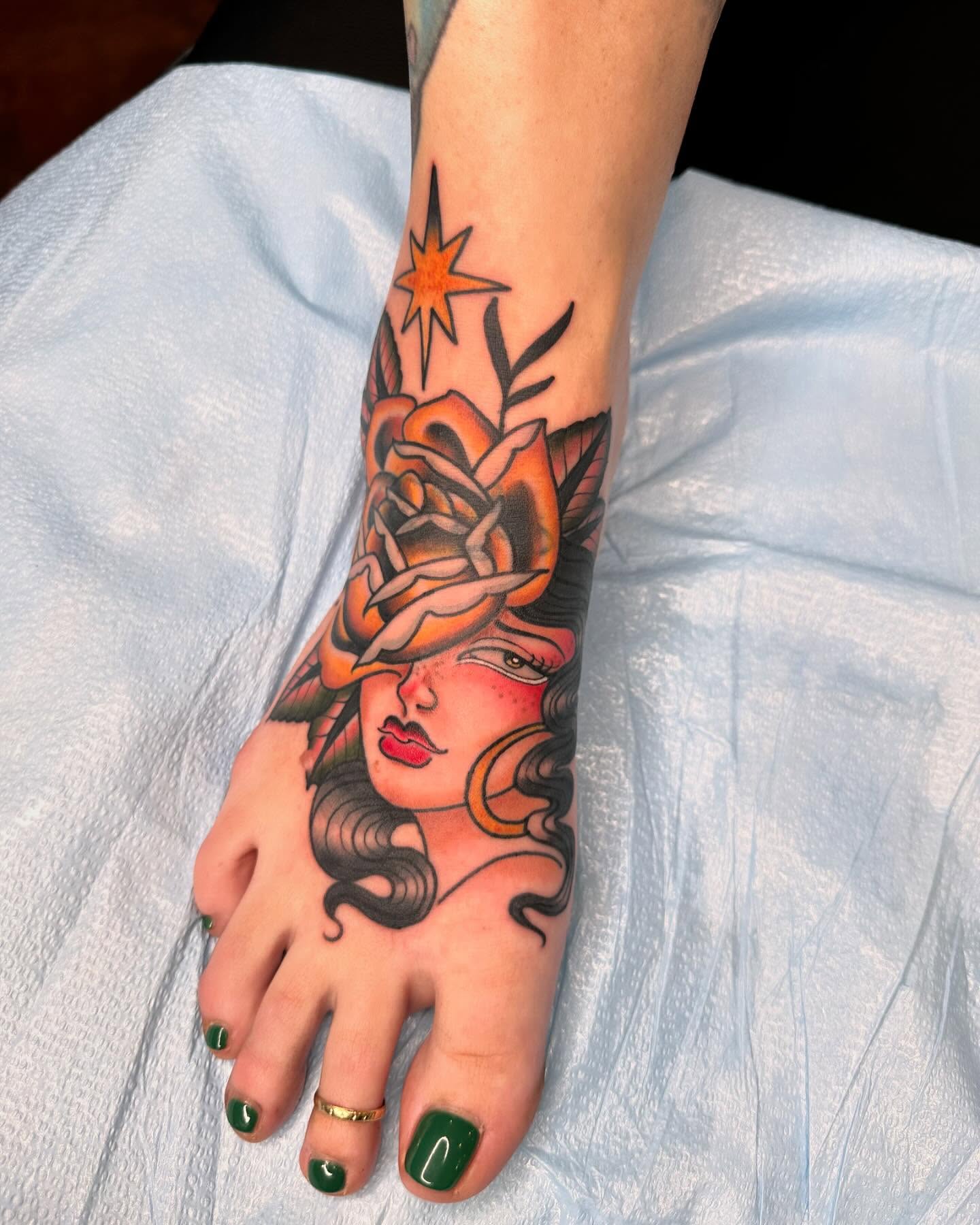 Woman with rose American traditional tattoo on the foot by Mika Clairissa