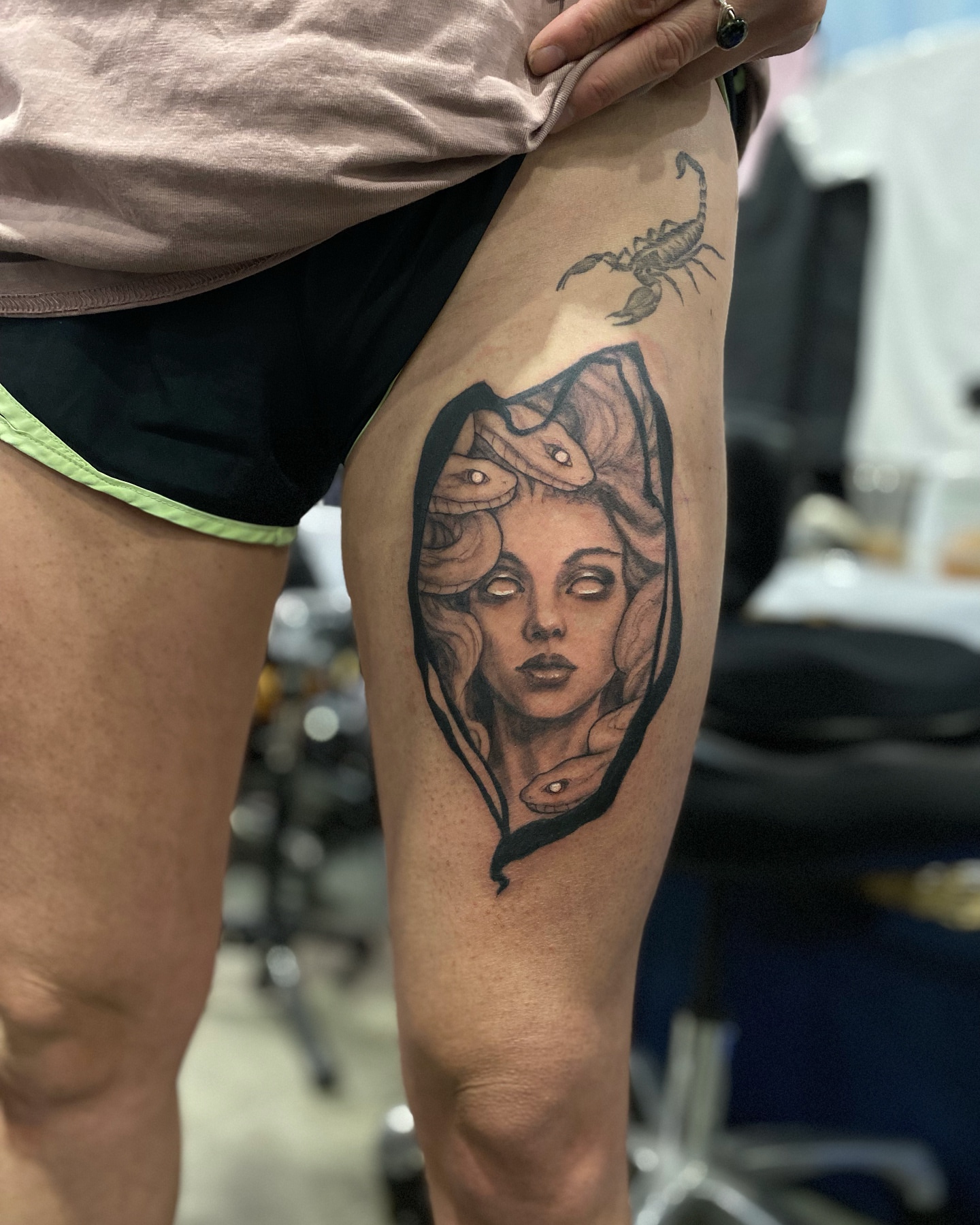 Woman with snakes realism tattoo on the thigh by Dana Jones