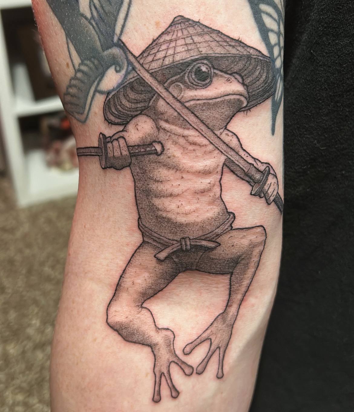Frog samurai realism tattoo on the forearm by Roman Butryy