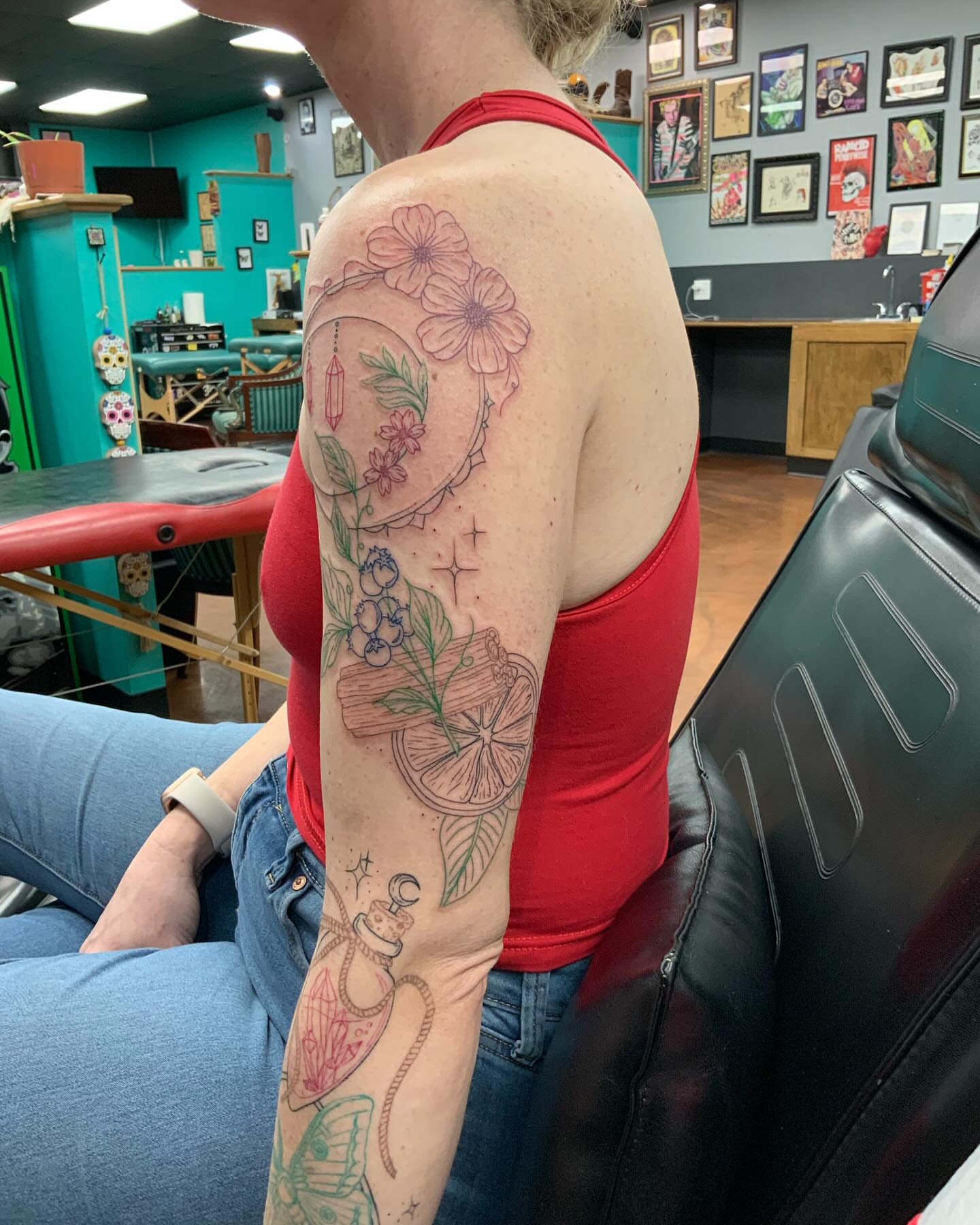 Fruit and floral new school tattoo on the upper arm by QUEEN TATTOO Stephanie Larson