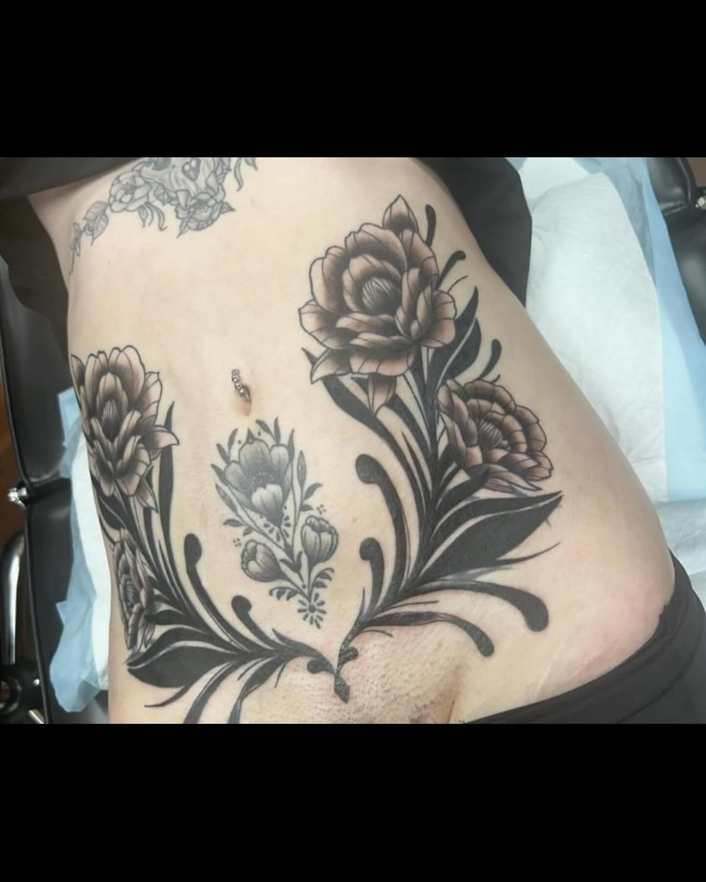Floral arrangement black and grey tattoo on the thigh by QUEEN TATTOO Stephanie Larson