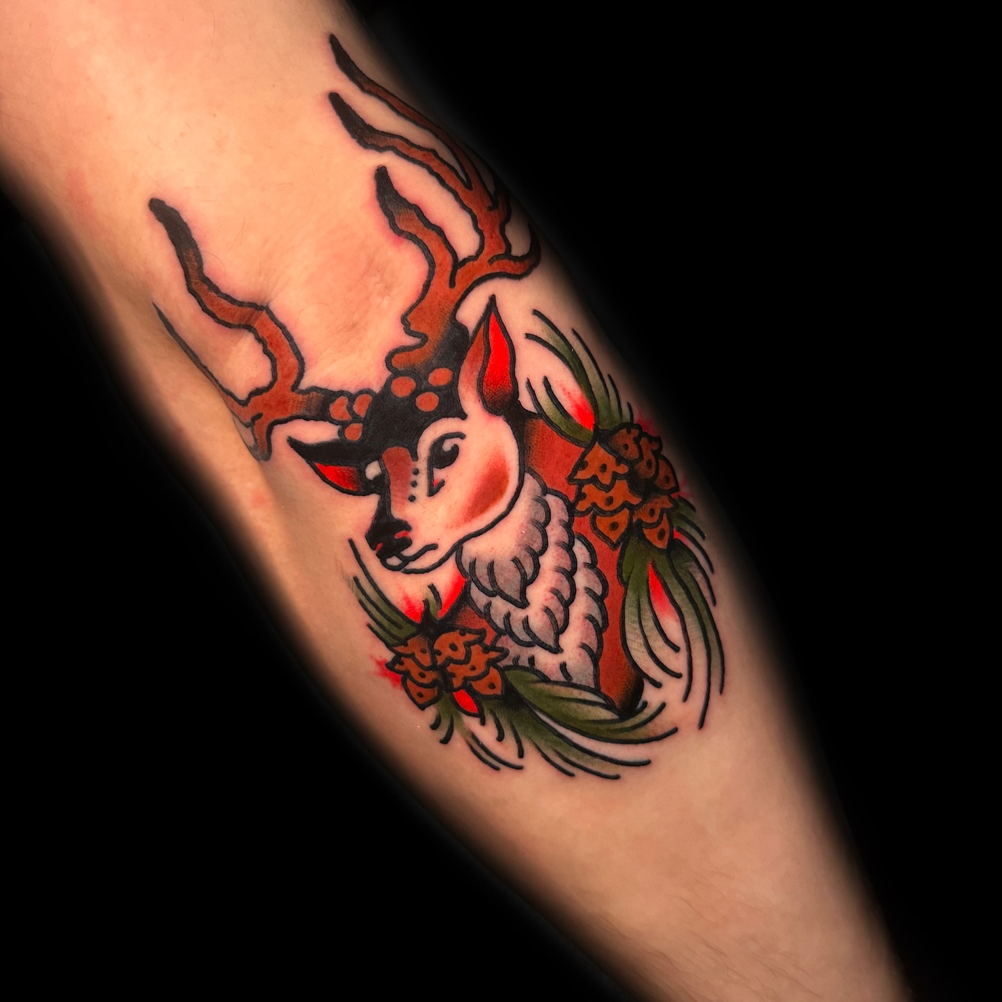 Deer and pinecone American traditional tattoo on the forearm by Danny Reis