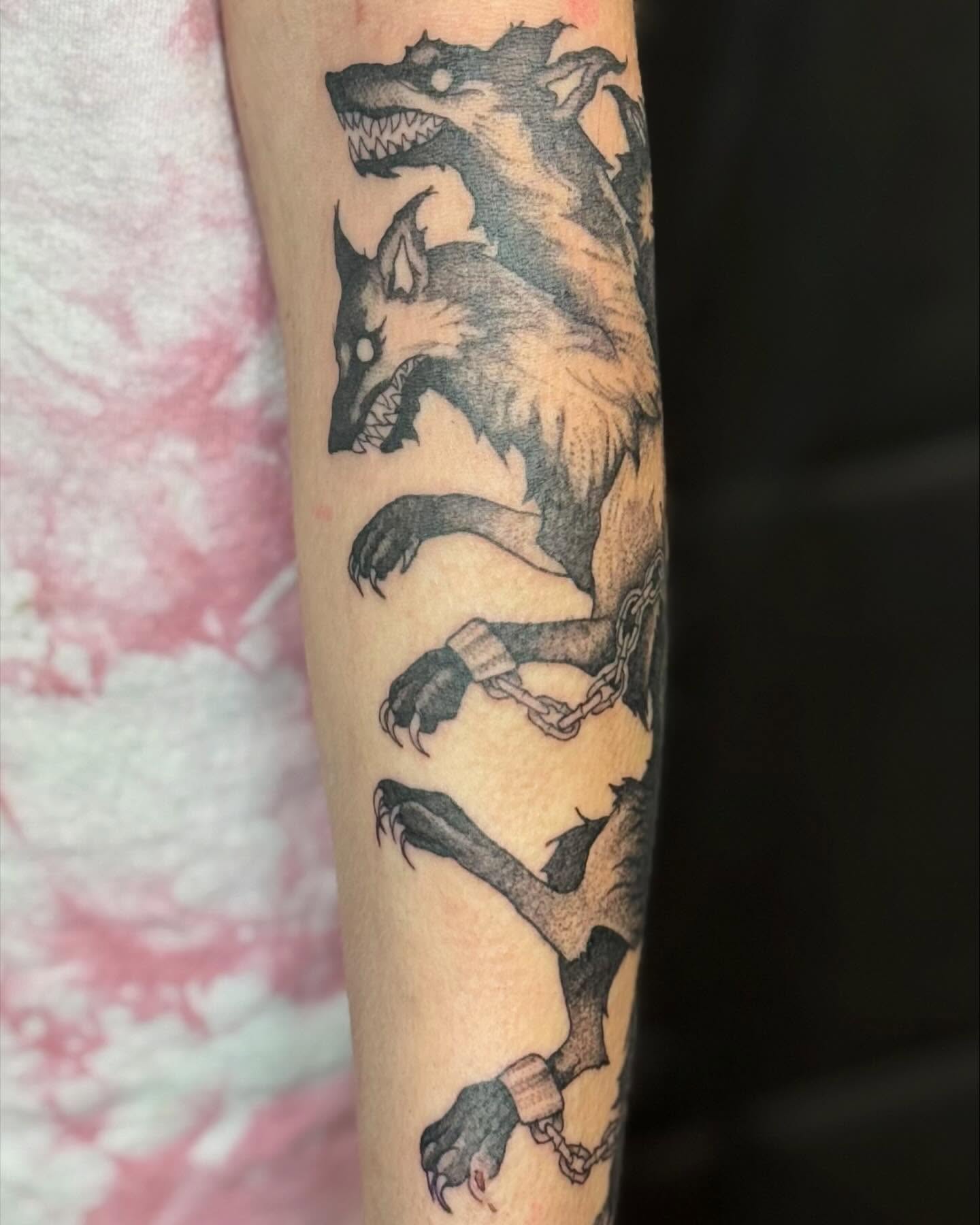 Wolf black and grey tattoo on the forearm by Katie Stacy