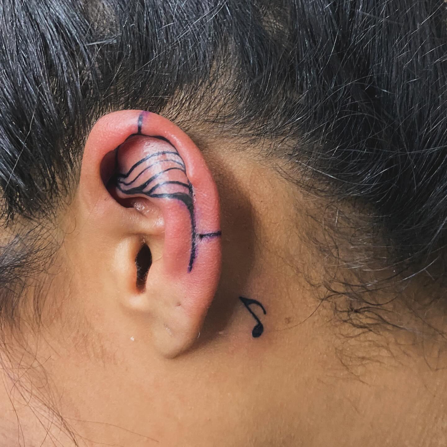 Ear with musical notes fine line tattoo on the neck by Tiffany