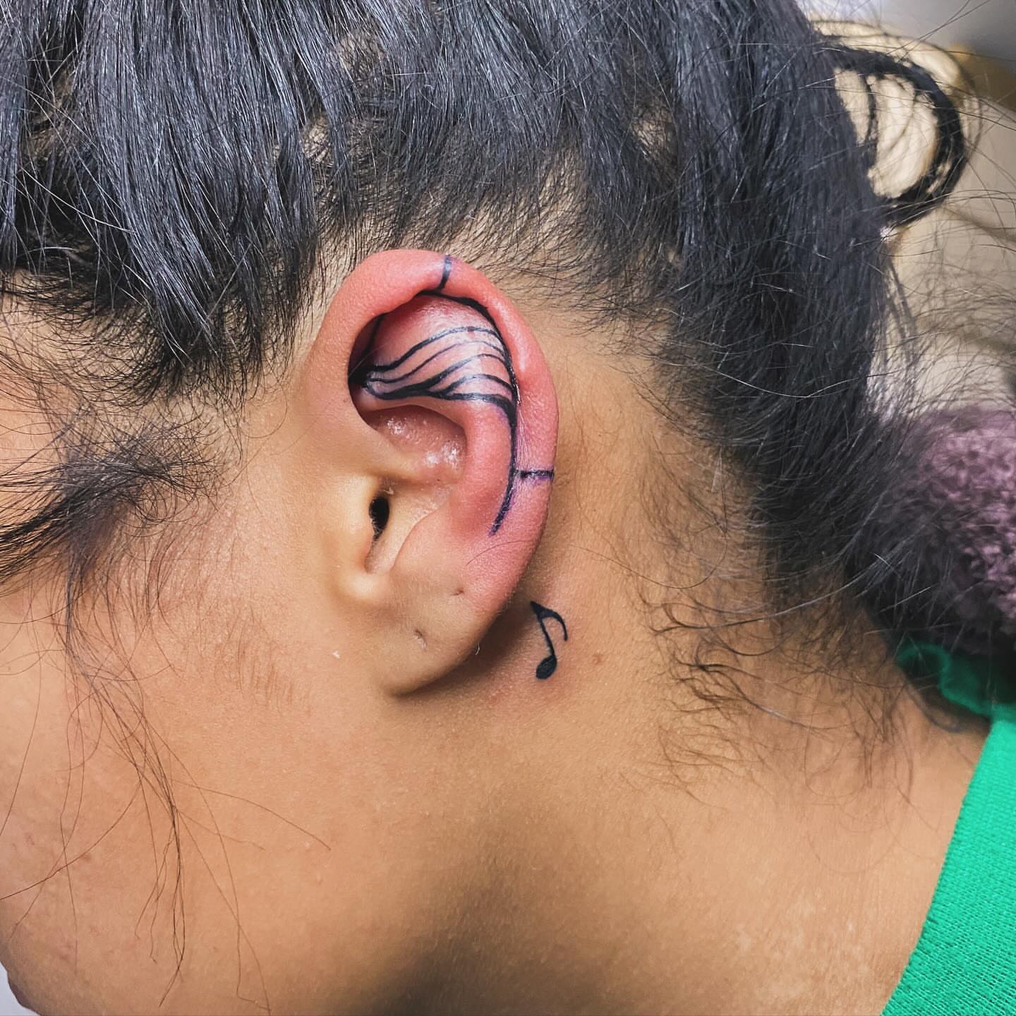 Music note fine line tattoo by Tiffany