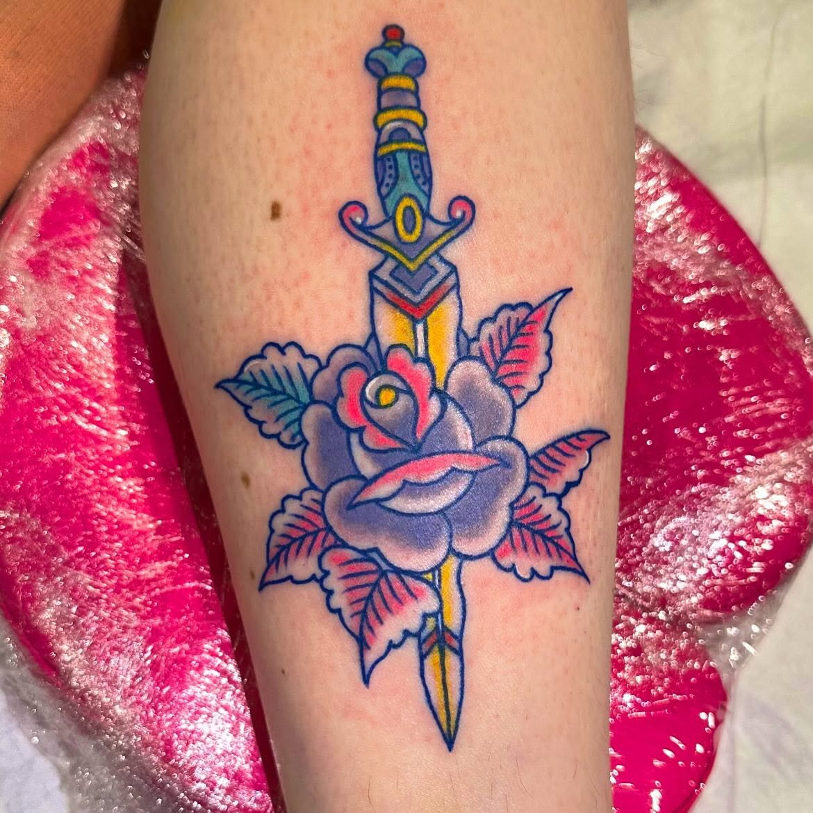 Sword and rose American traditional tattoo on the forearm by Olive Kelley