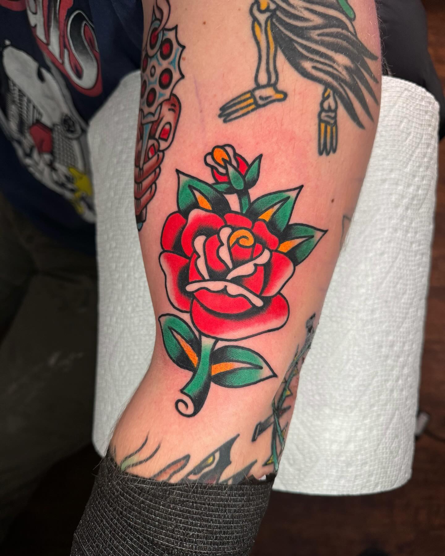Red rose American traditional tattoo on the forearm by James Shepherd, Austin, Texas