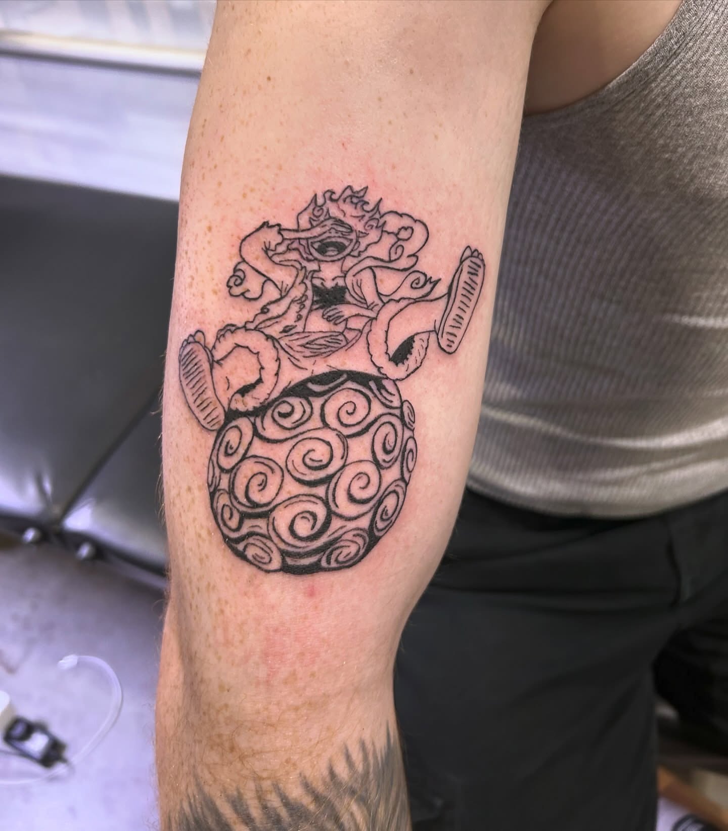 Lion and sphere black and grey tattoo on the forearm by Shampooh