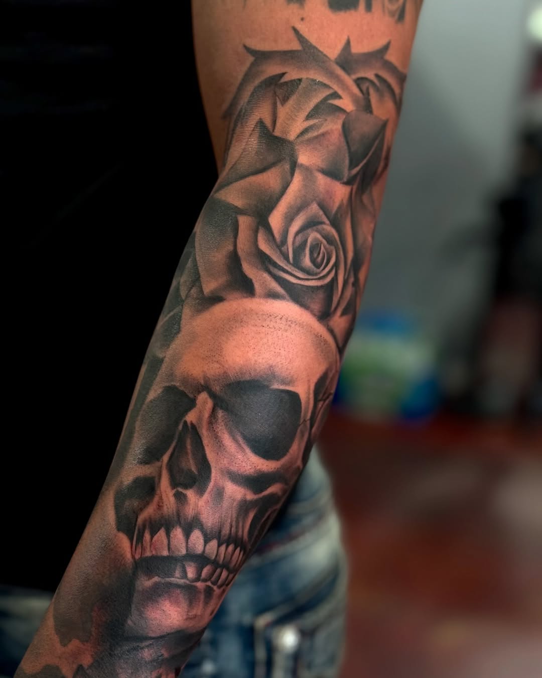 Skull and rose realism tattoo on the forearm by Stephanie Cruz, Kansas City, Missouri