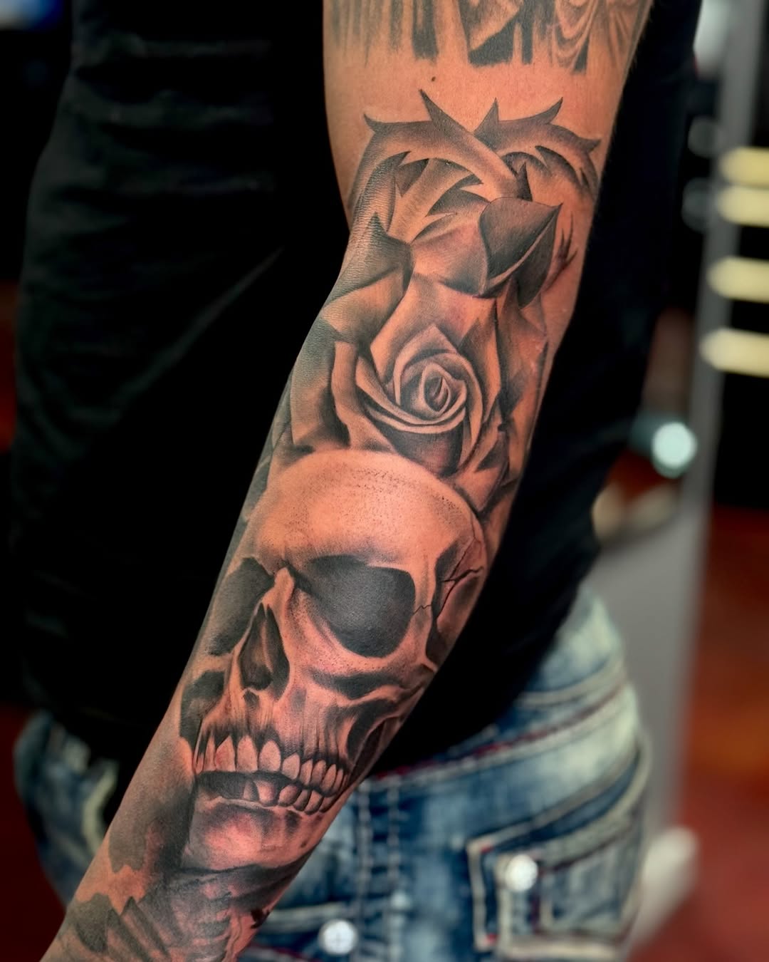 Skull and rose realism tattoo on the forearm by Stephanie Cruz, Kansas City, Missouri