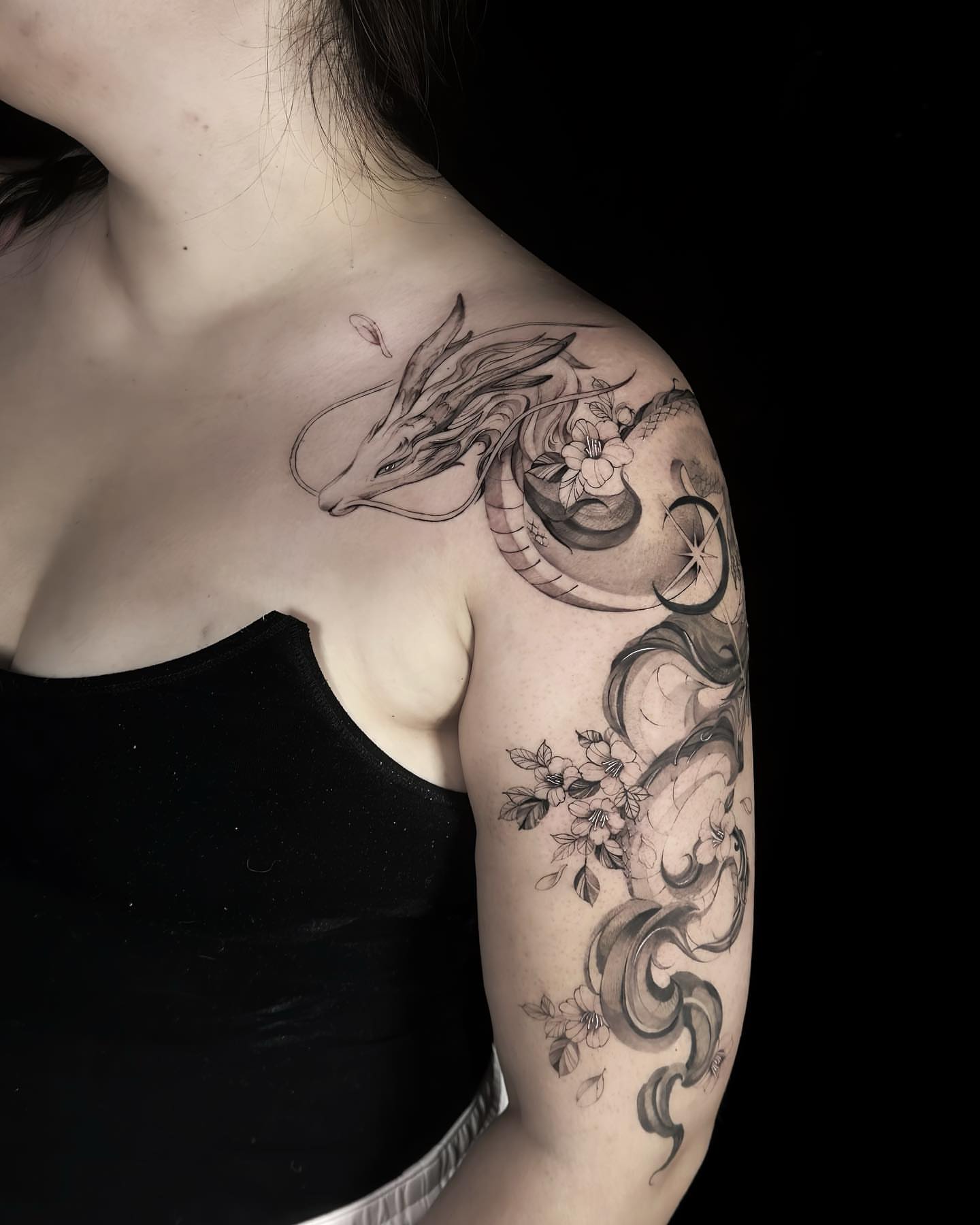 Dragon and flowers realism tattoo on the shoulder by Alice Li, Houston, Texas