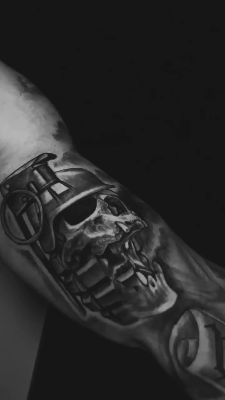 Skull in a helmet dark realism tattoo by Joe Shepp