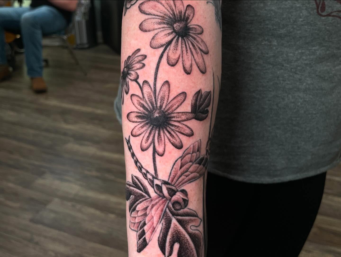 Daisies dotwork tattoo on the forearm by Caleb Baker
