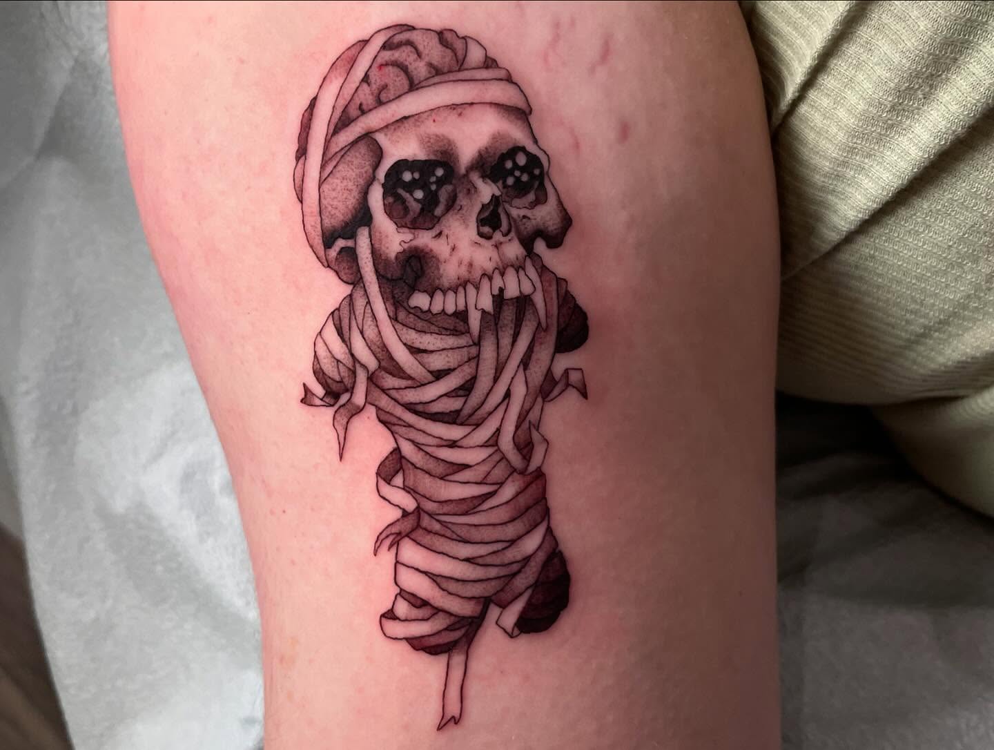 Mummy black and grey tattoo on the thigh by Caleb Baker