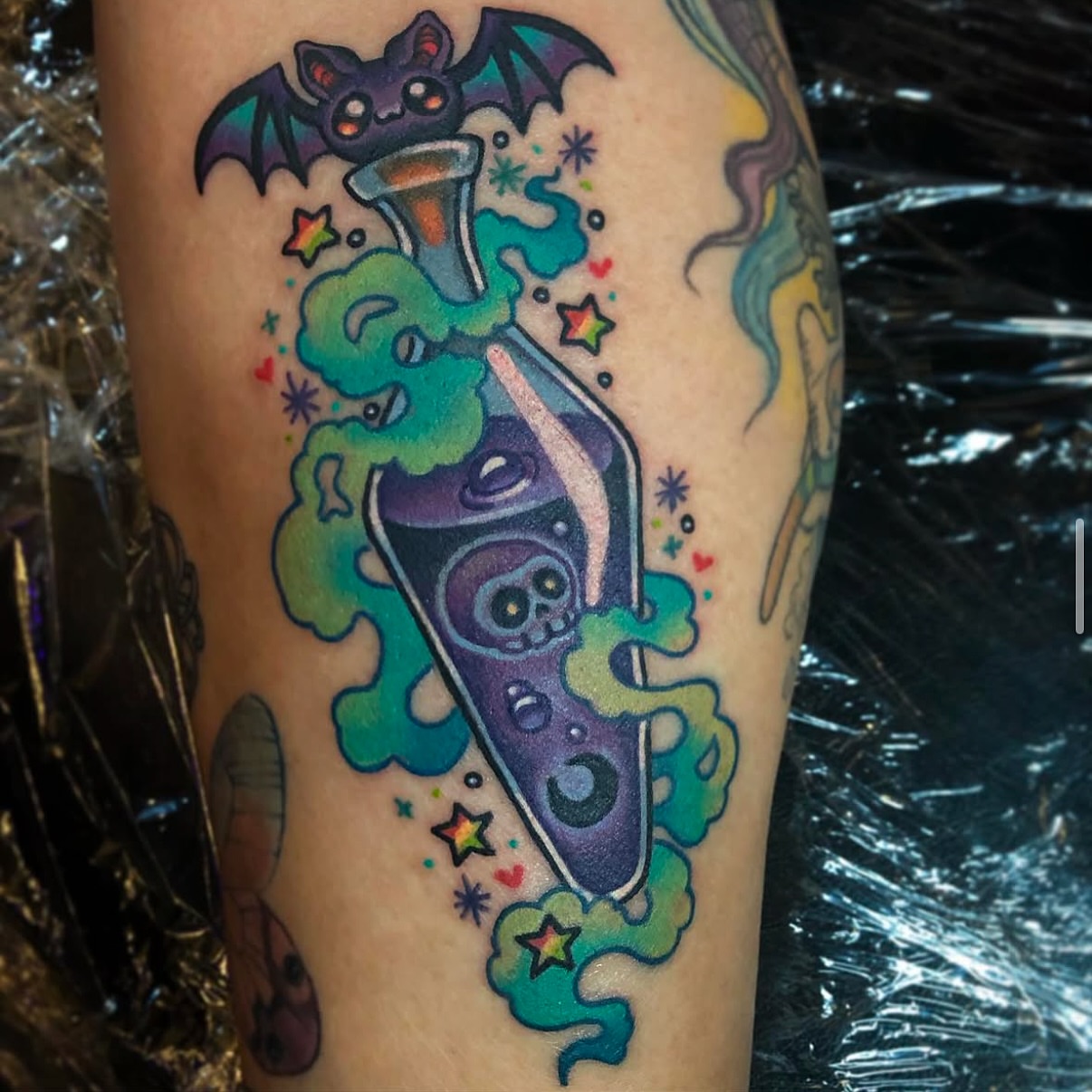 Bat and potion bottle American traditional tattoo on the forearm by Alexandra Fische