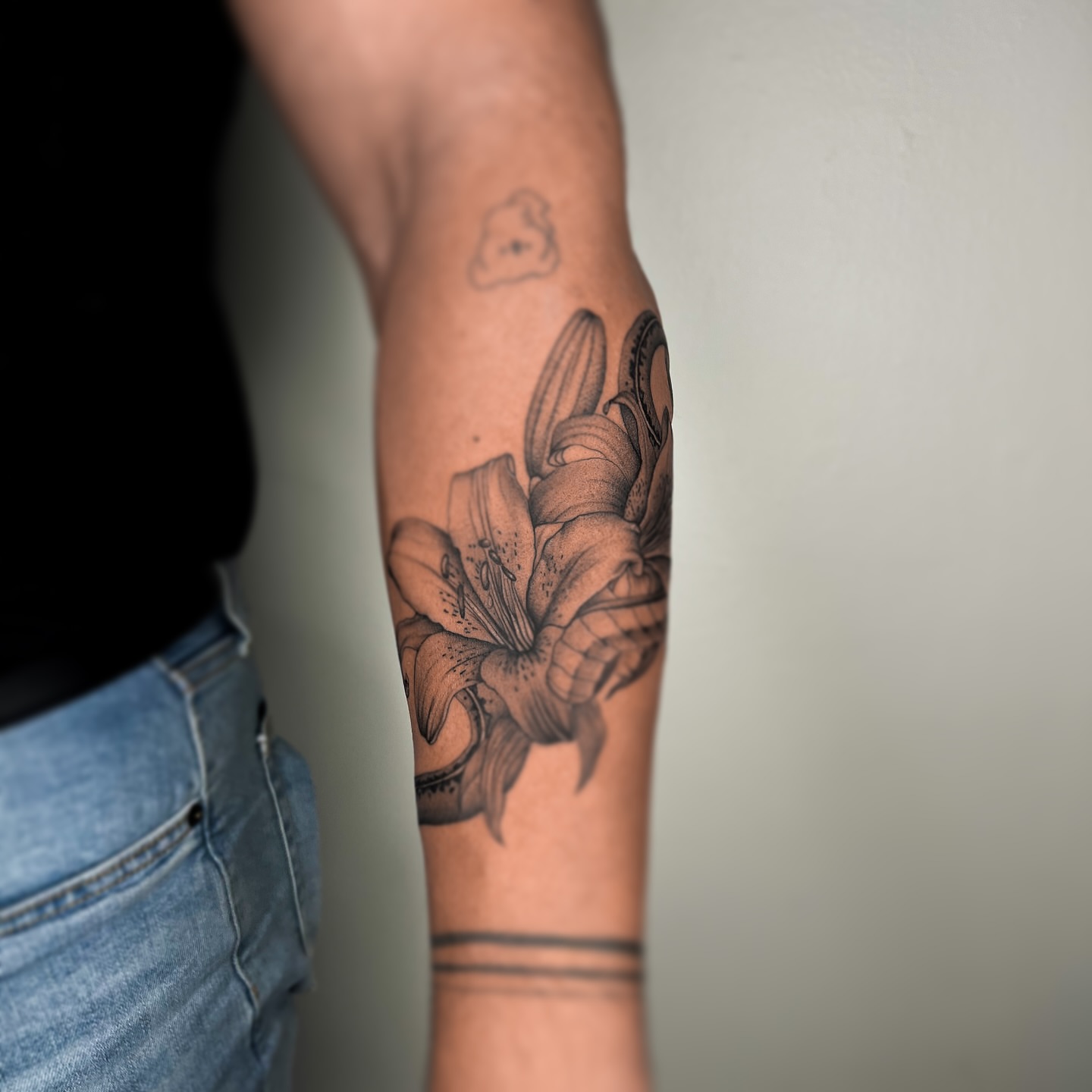 Lily black and grey tattoo on the forearm by Priscila, Los Angeles, California