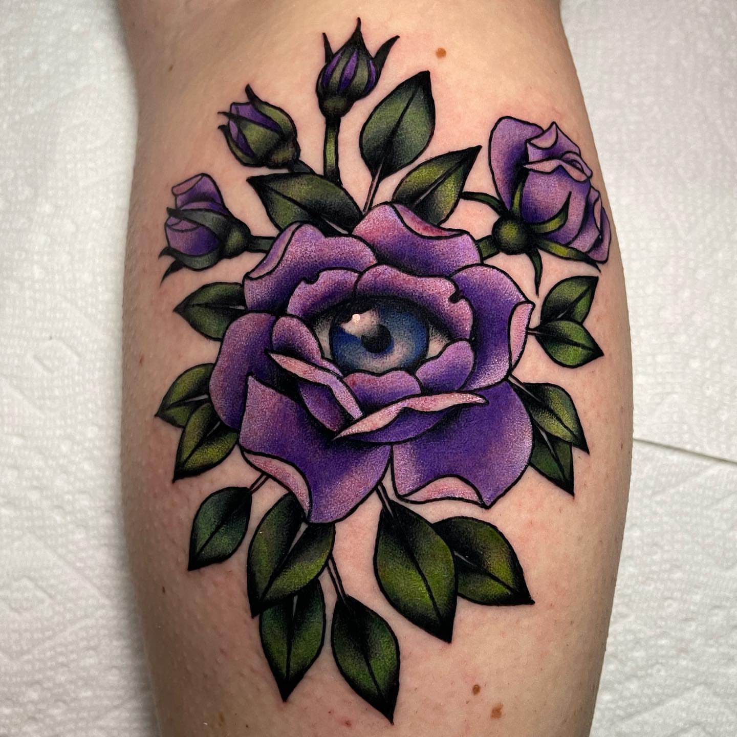 Purple roses American traditional tattoo on the thigh by Marqui Watling