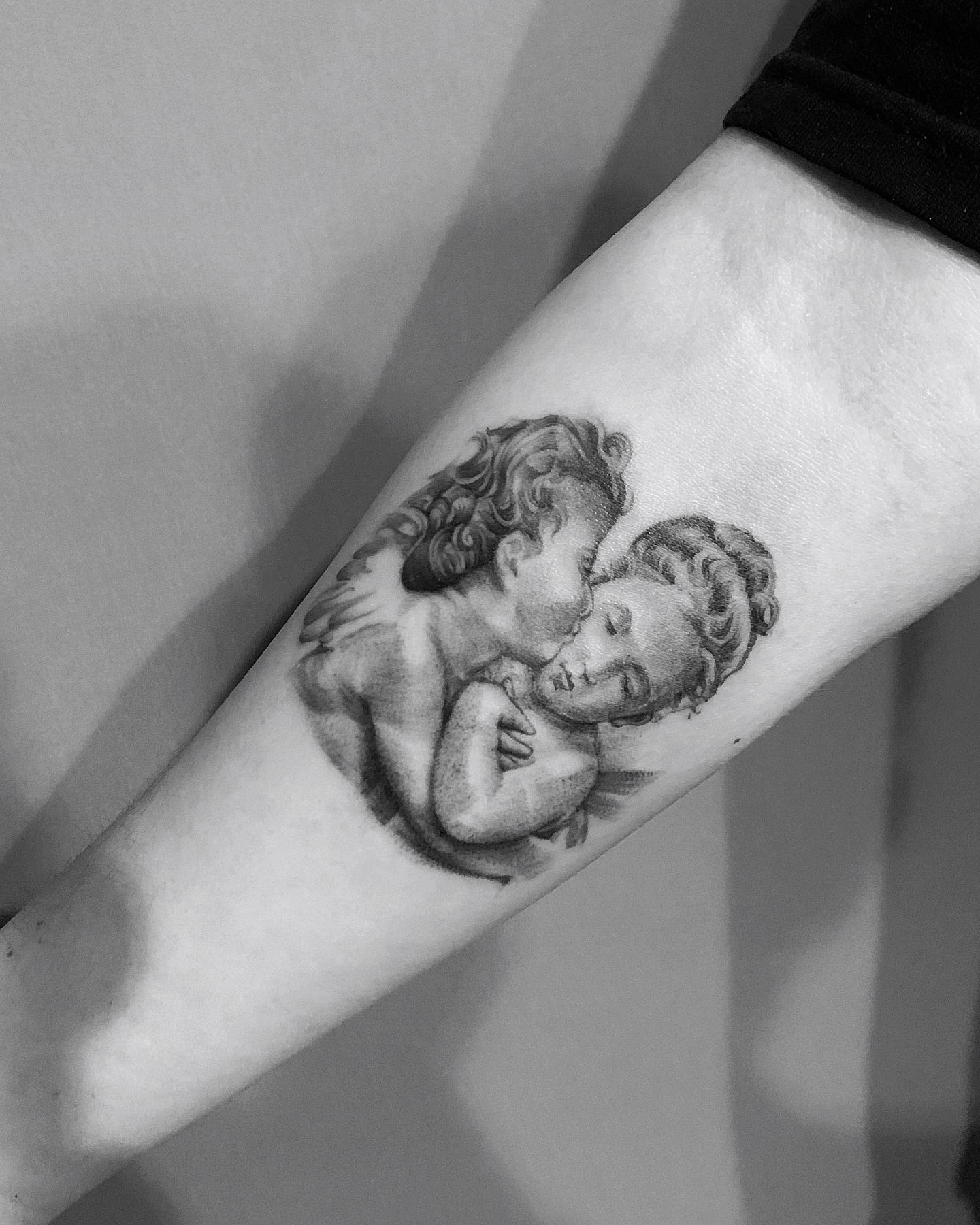 Couple embracing realism tattoo on the forearm by elvis flores