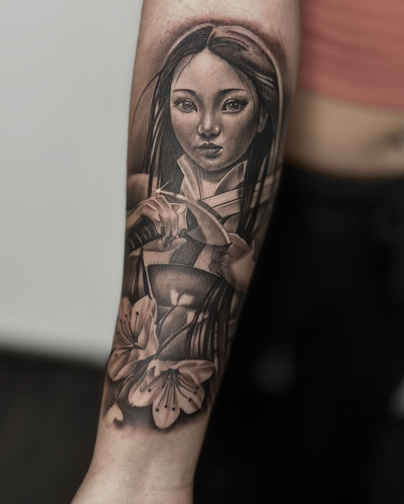 Geisha with cherry blossoms realism tattoo on the forearm by Aaron Watson