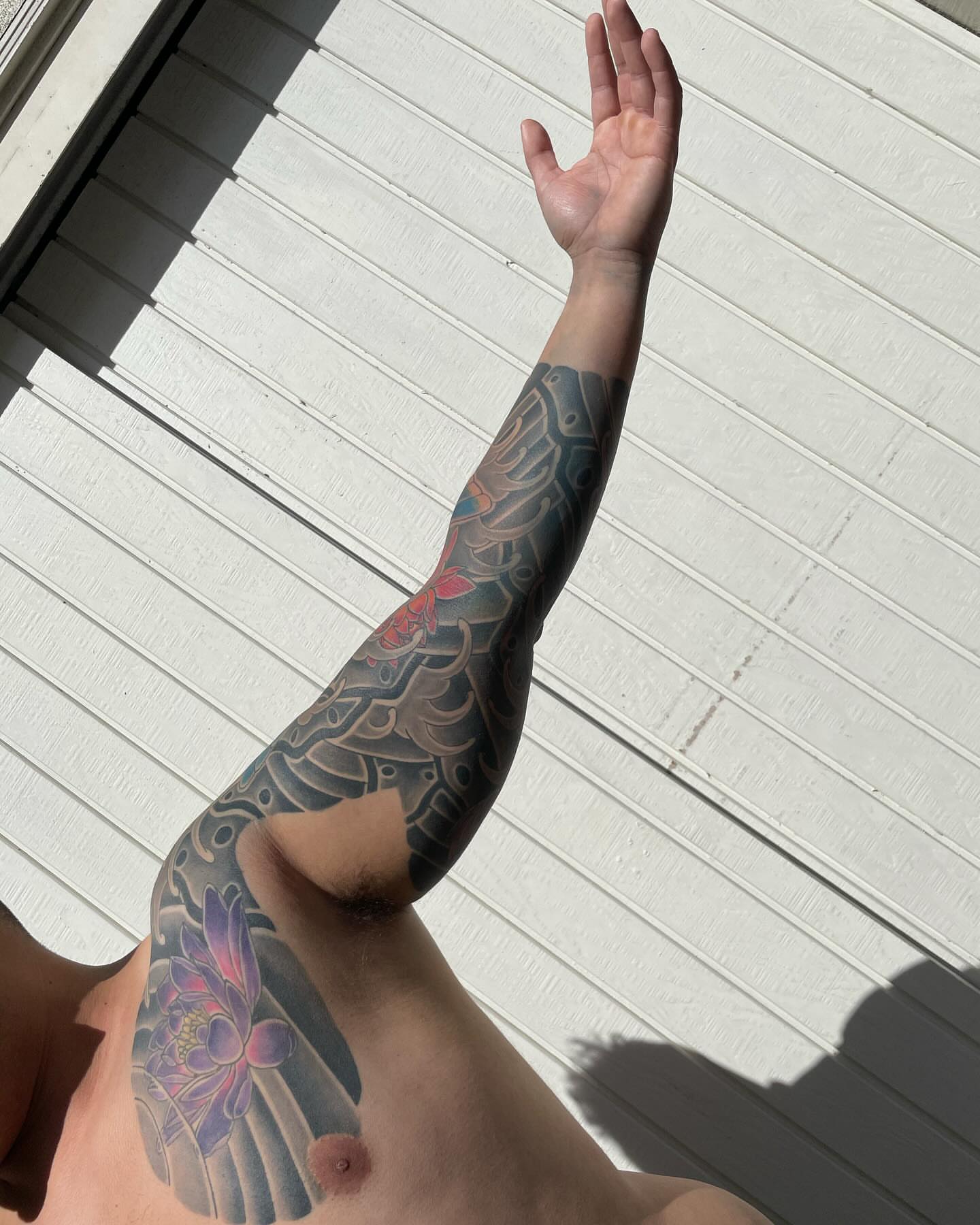 Koi fish and lotus flower japanese irezumi tattoo on the upper arm by Ei Horimiya Omiya