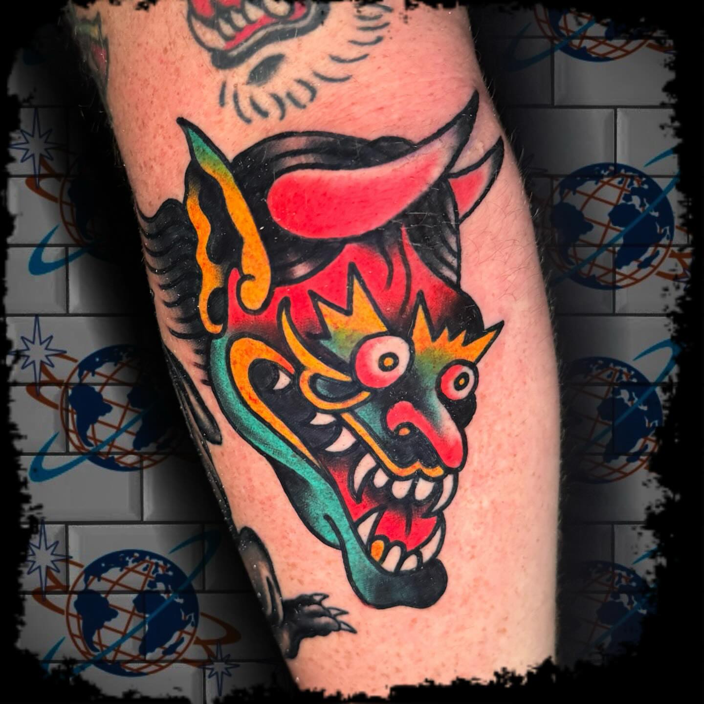 Demon mask American traditional tattoo on the forearm by Antonio DeCaro