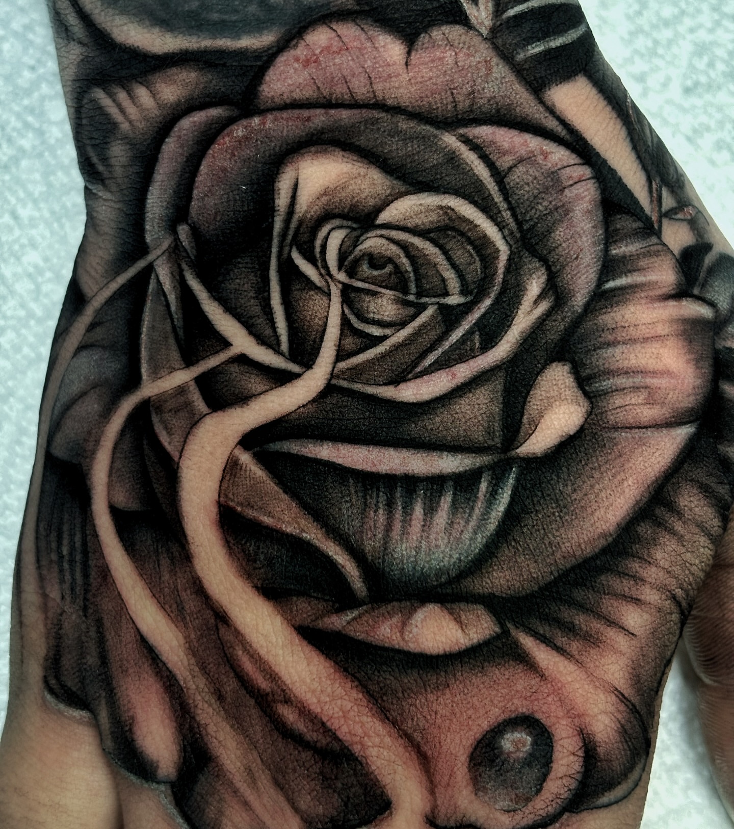 Rose realism tattoo on the hand by Alejo Ibanez Tattoo