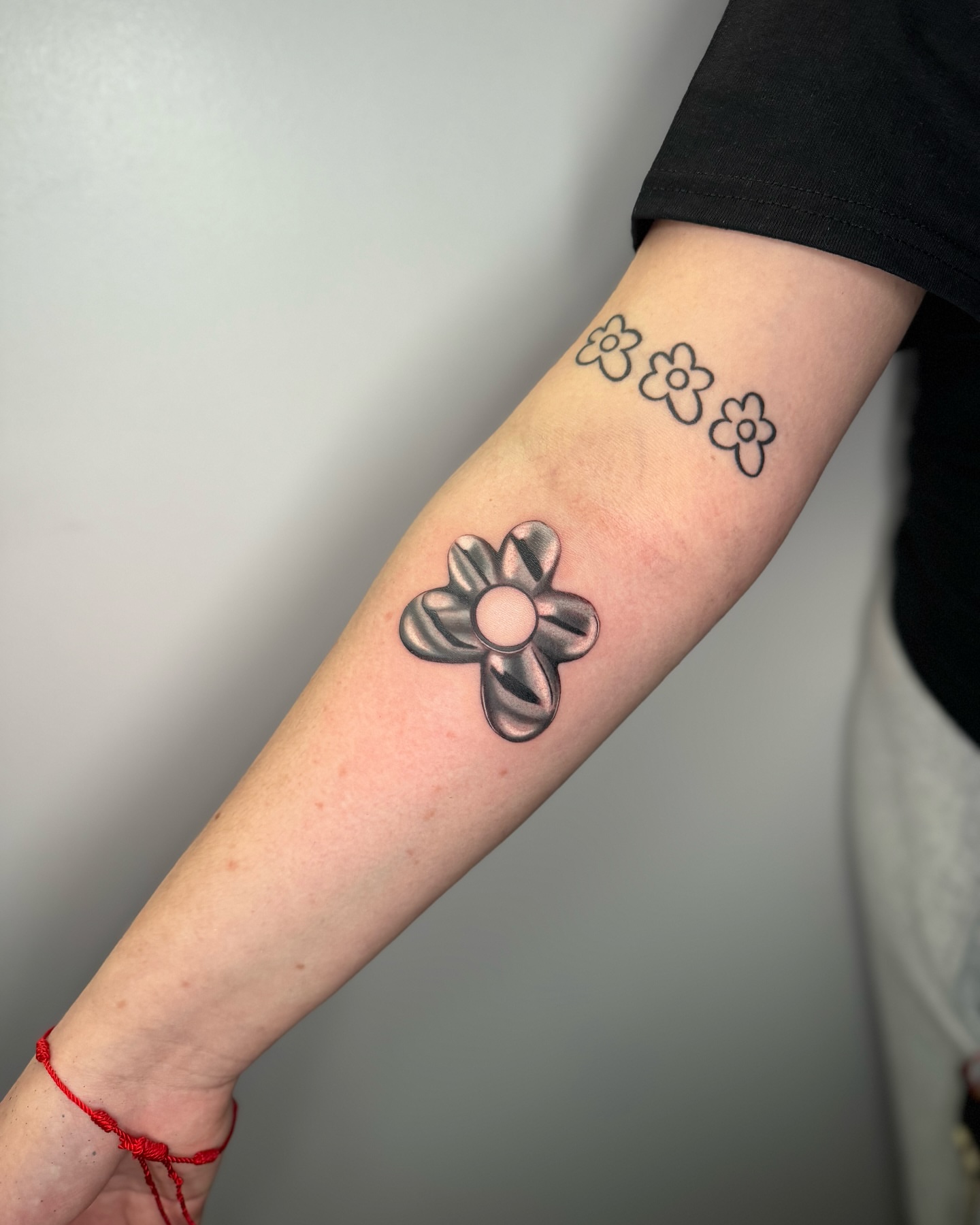 Flower black and grey tattoo on the forearm by Mel