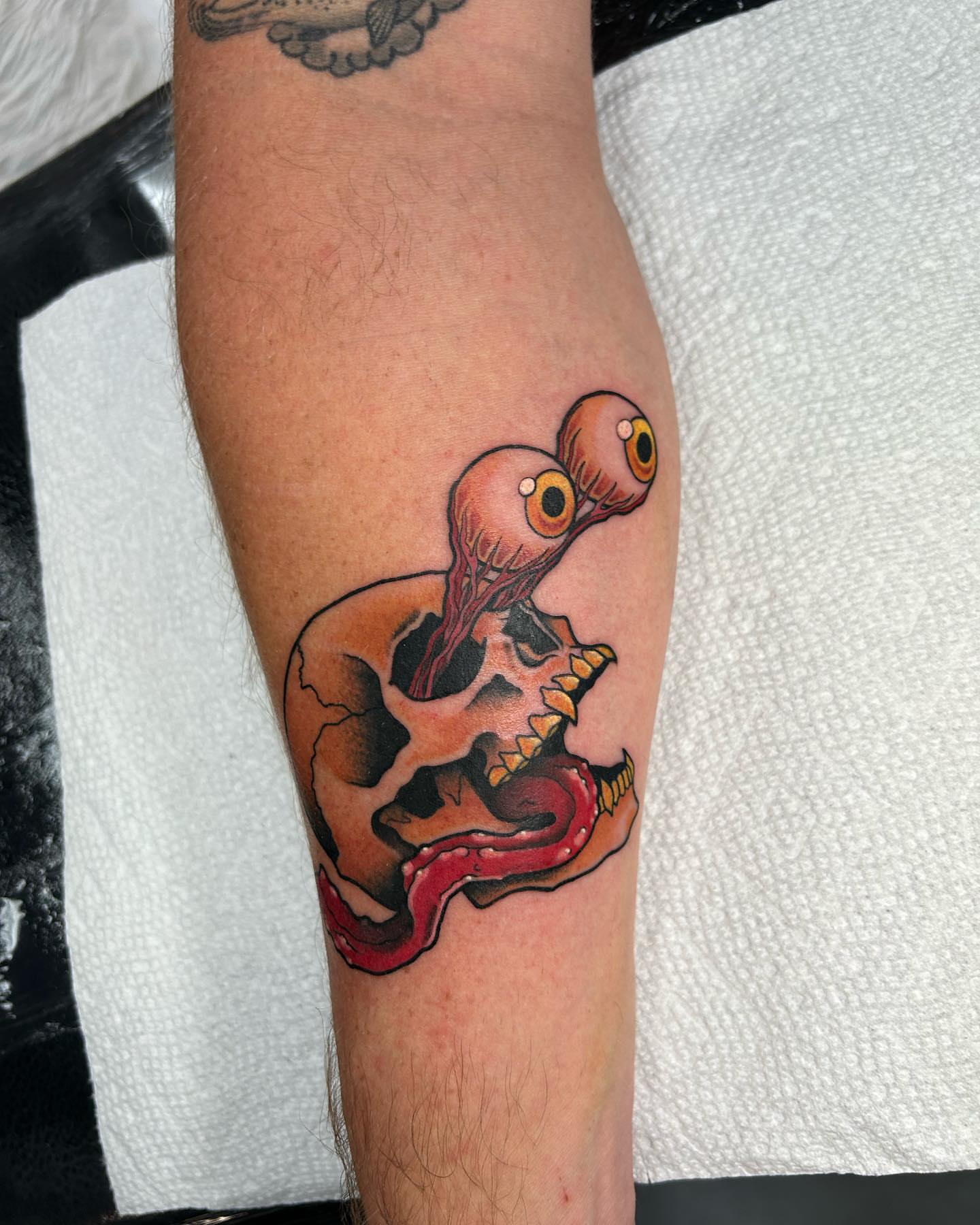 Skull with eyes American traditional tattoo on the forearm by Lexi Kniskern