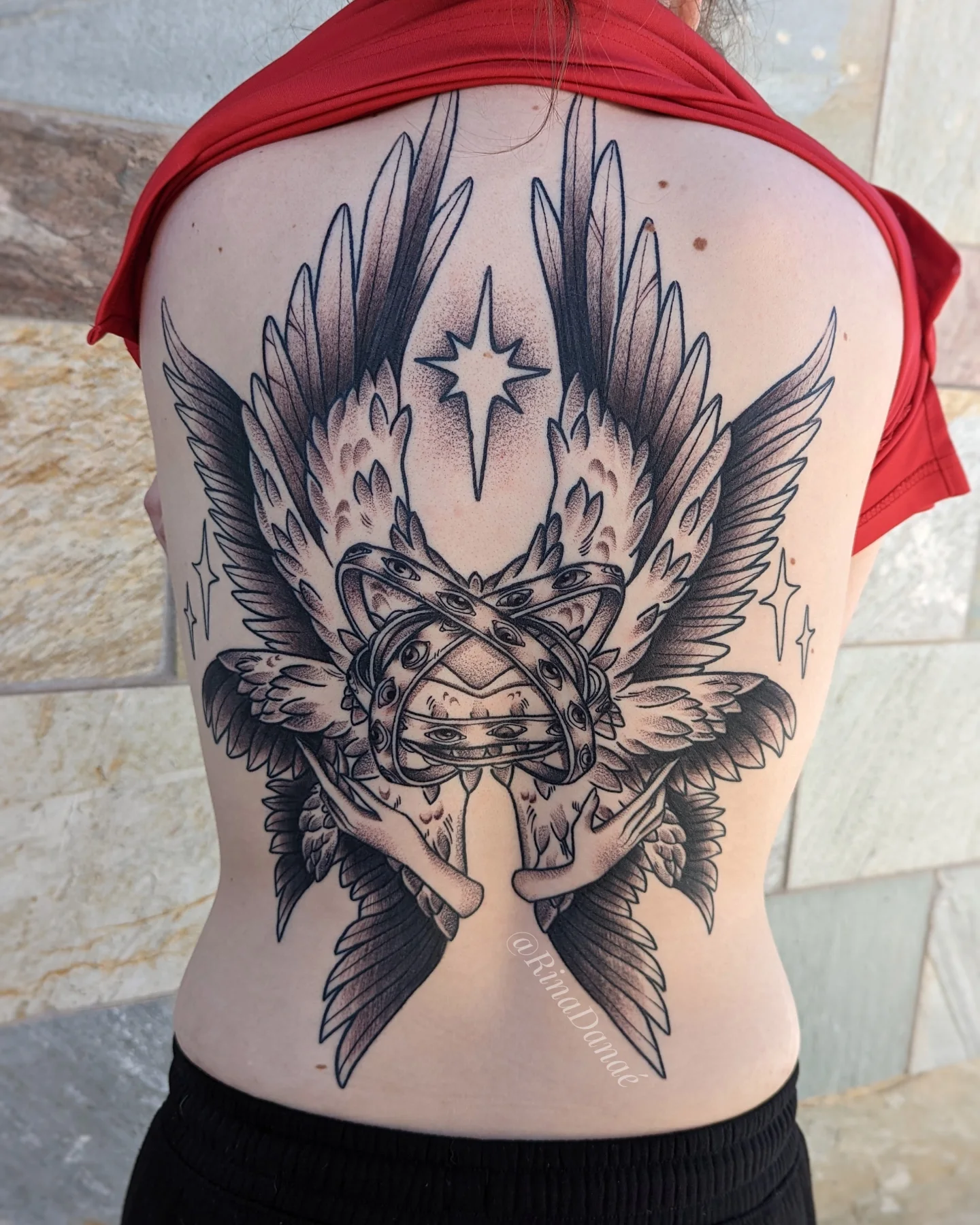 Wings and helmet American traditional tattoo on the back by Rina Danaé Tattoo🌿