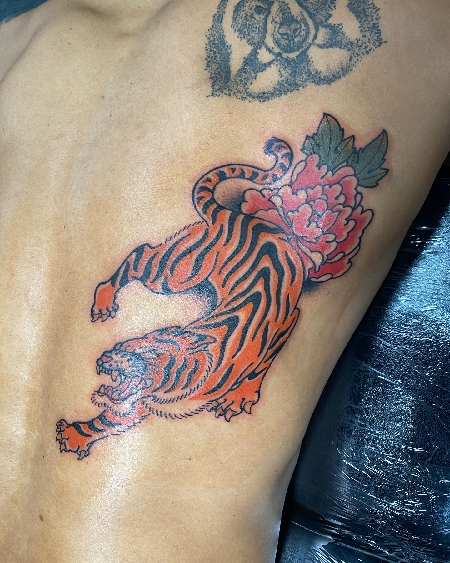 Tiger and peony American traditional tattoo on the thigh by S C O T T
