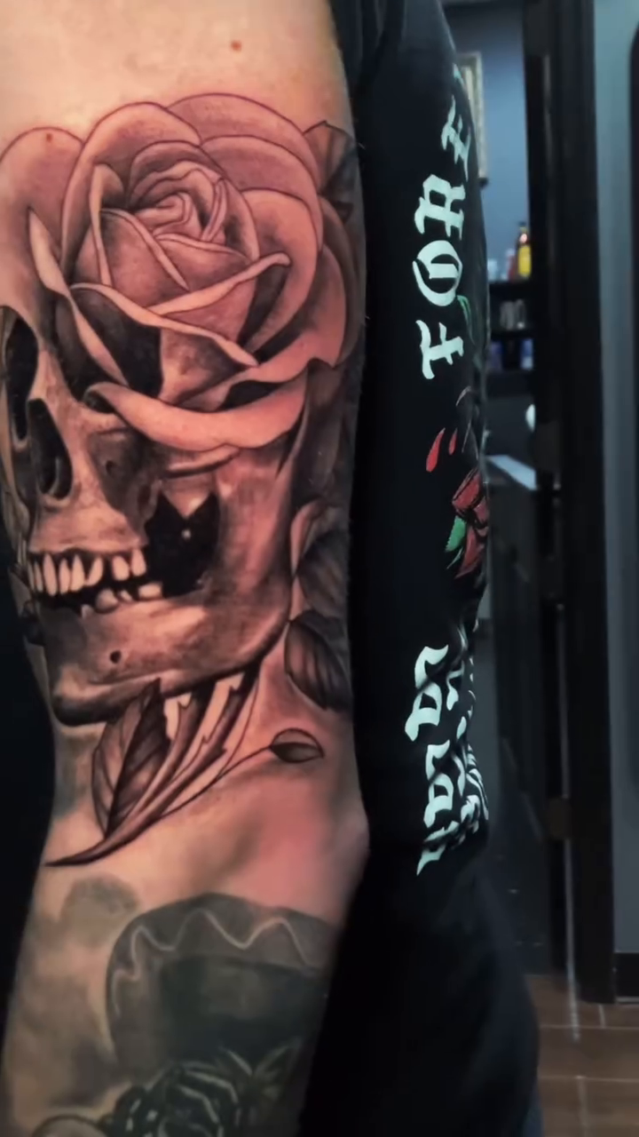 Skull and rose realism tattoo by Joe Shepp